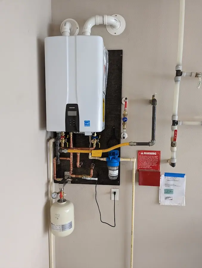 Professional plumber installing copper piping in a Haskell home